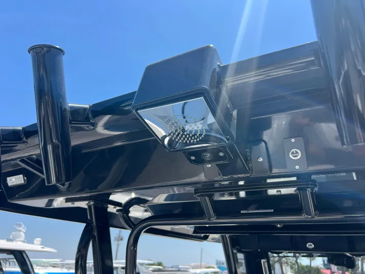  Yacht Photos Pics 2025 Robalo R300 Center Console boat roof detail with mounted light and rod holders.