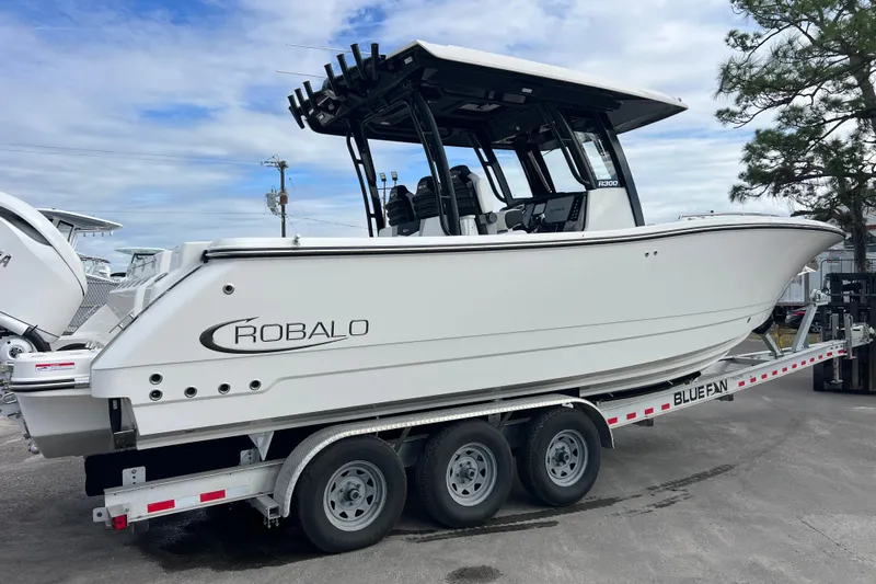  Yacht Photos Pics 2025 Robalo R300 Center Console boat on trailer, side view.