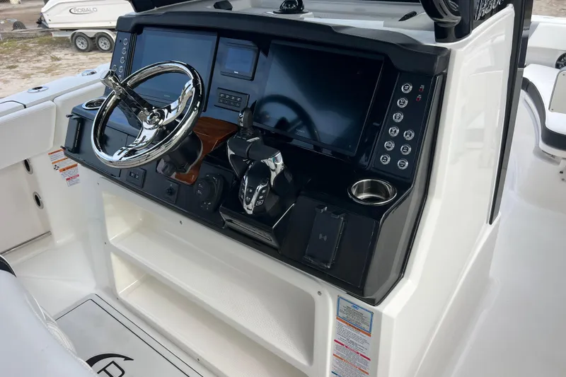  Yacht Photos Pics 2025 Robalo R300 Center Console boat dashboard with steering wheel and modern controls.