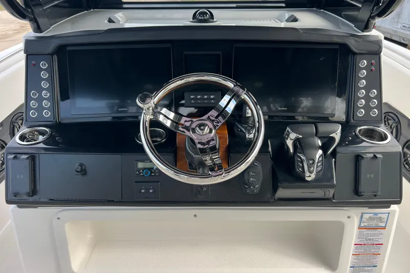  Yacht Photos Pics 2025 Robalo R300 Center Console dashboard with steering wheel and modern controls.