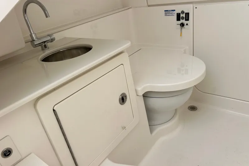  Yacht Photos Pics 2025 Robalo R300 Center Console boat bathroom with sink and toilet.