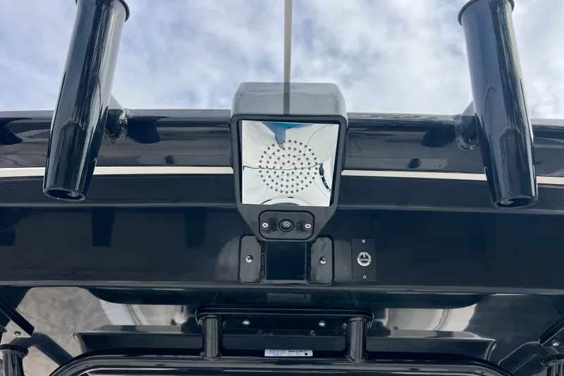  Yacht Photos Pics 2025 Robalo R300 Center Console boat with mounted equipment under cloudy sky.
