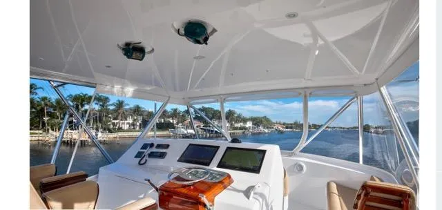 Farmers Daughter Yacht Photos Pics 2004 Viking 45 Convertible yacht helm with navigation screens and waterfront view.