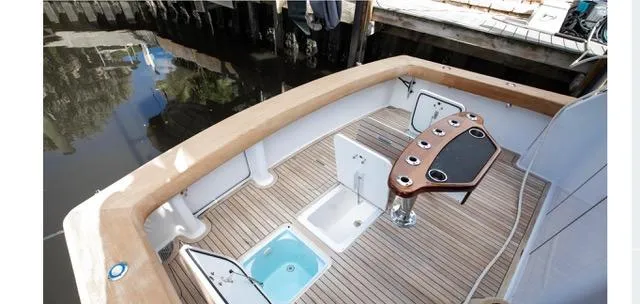 Farmers Daughter Yacht Photos Pics 2004 Viking 45 Convertible boat deck with fishing station and storage compartments.