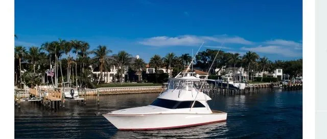 Farmers Daughter Yacht Photos Pics 2004 Viking 45 Convertible yacht cruising near waterfront homes and palm trees.