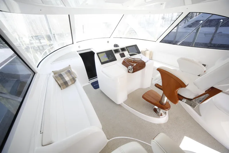 Brown Eyed Girl Yacht Photos Pics Luxurious interior of 2014 Viking 42 Sport Tower yacht with modern helm and seating.