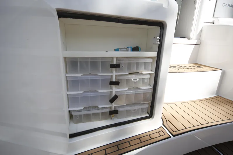 Brown Eyed Girl Yacht Photos Pics Storage compartment with organized tackle boxes on a 2014 Viking 42 Sport Tower boat.