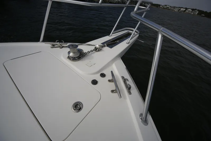 Brown Eyed Girl Yacht Photos Pics 2014 Viking 42 Sport Tower boat deck with anchor and railing, on calm water.
