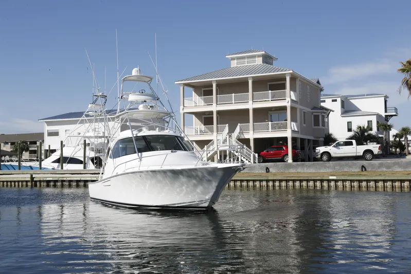 Brown Eyed Girl Yacht Photos Pics 2014 Viking 42 Sport Tower yacht docked near waterfront homes.