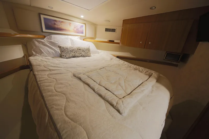 Brown Eyed Girl Yacht Photos Pics Cozy bedroom interior of 2014 Viking 42 Sport Tower yacht with plush bedding.