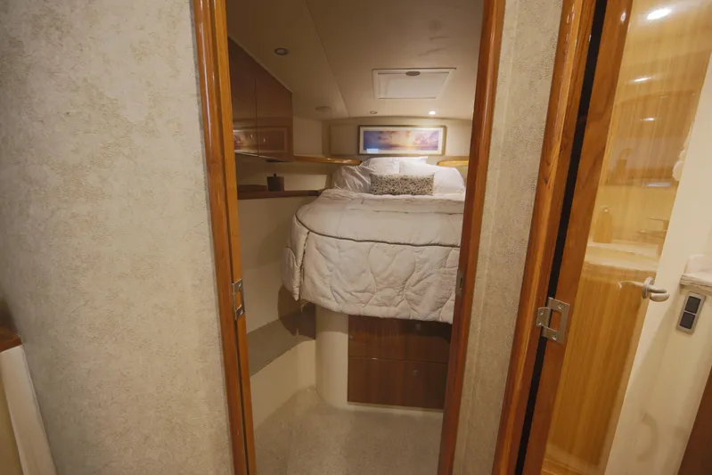 Brown Eyed Girl Yacht Photos Pics 2014 Viking 42 Sport Tower cabin interior with cozy bed and wooden accents.
