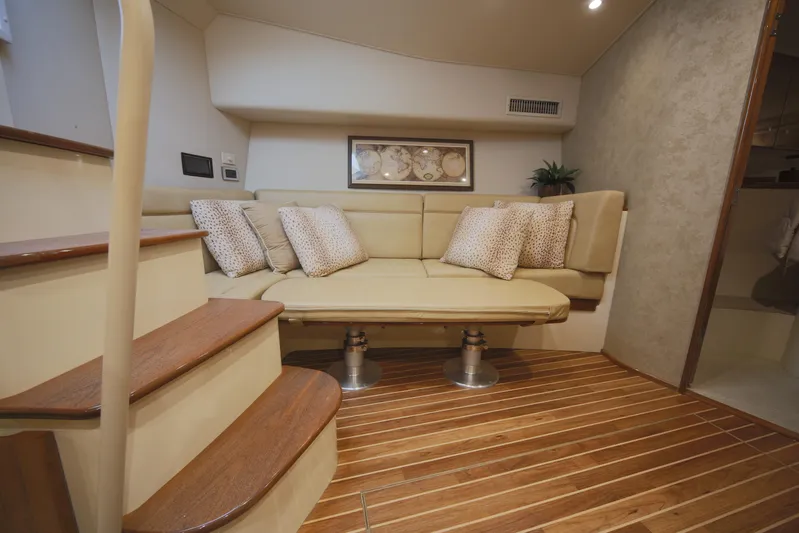 Brown Eyed Girl Yacht Photos Pics Interior of 2014 Viking 42 Sport Tower with beige seating and wooden flooring.