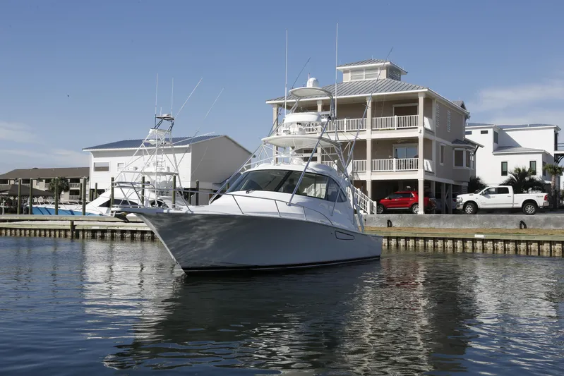 Brown Eyed Girl Yacht Photos Pics 2014 Viking 42 Sport Tower yacht docked near waterfront homes.