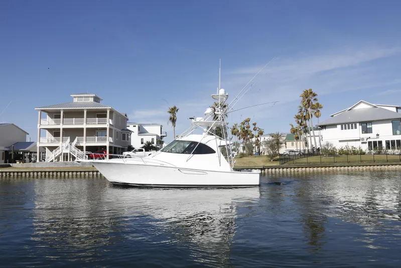 Brown Eyed Girl Yacht Photos Pics 2014 Viking 42 Sport Tower yacht on calm water near waterfront homes.