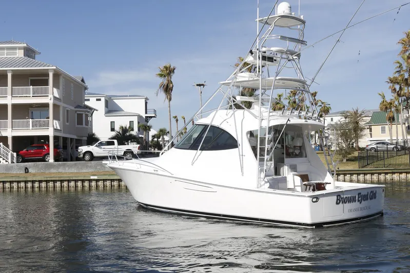 Brown Eyed Girl Yacht Photos Pics 2014 Viking 42 Sport Tower yacht docked near waterfront homes.