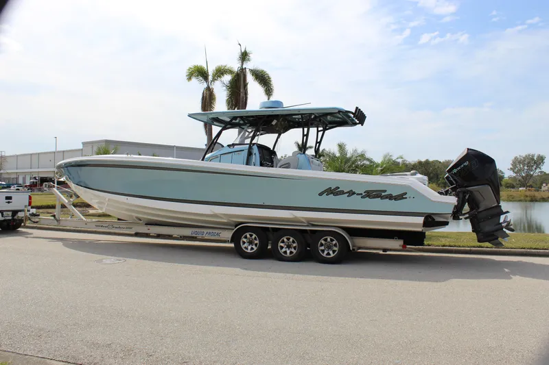  Yacht Photos Pics 2021 Nor-Tech 390 Sport Center Console boat on a trailer, parked near a waterfront.