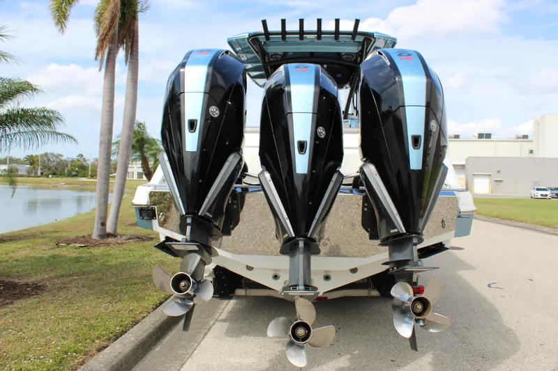  Yacht Photos Pics 2021 Nor-Tech 390 Sport Center Console with triple outboard engines, parked near a lake.