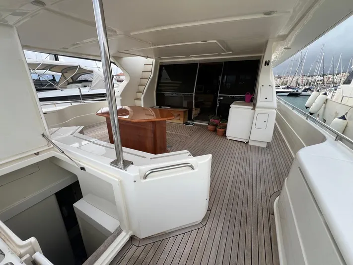  Yacht Photos Pics Luxurious 2002 Ferretti Yachts 810 with spacious deck and elegant wooden table.