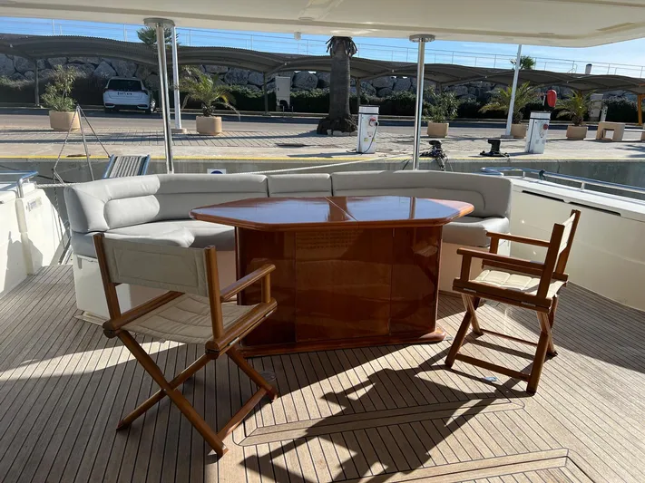  Yacht Photos Pics Luxurious 2002 Ferretti Yachts 810 deck with seating and wooden table.