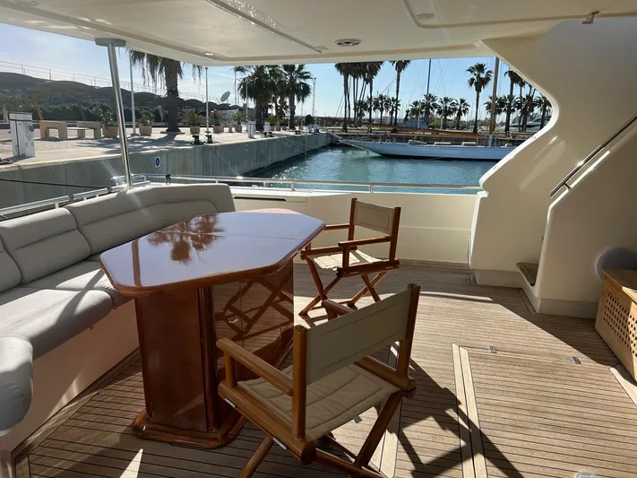  Yacht Photos Pics Luxurious 2002 Ferretti Yachts 810 deck with seating, table, and marina view.