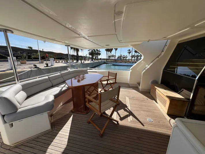  Yacht Photos Pics Luxurious 2002 Ferretti Yachts 810 deck with seating, table, and marina view.