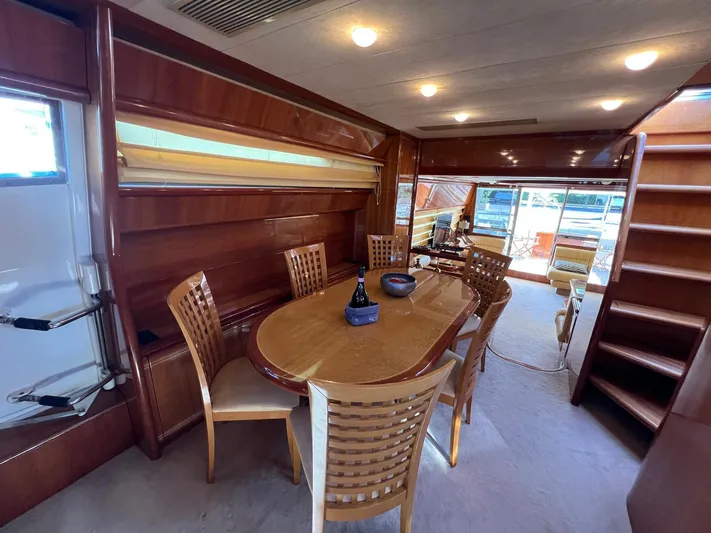  Yacht Photos Pics Luxurious interior of 2002 Ferretti Yachts 810 with elegant dining area and wooden finishes.