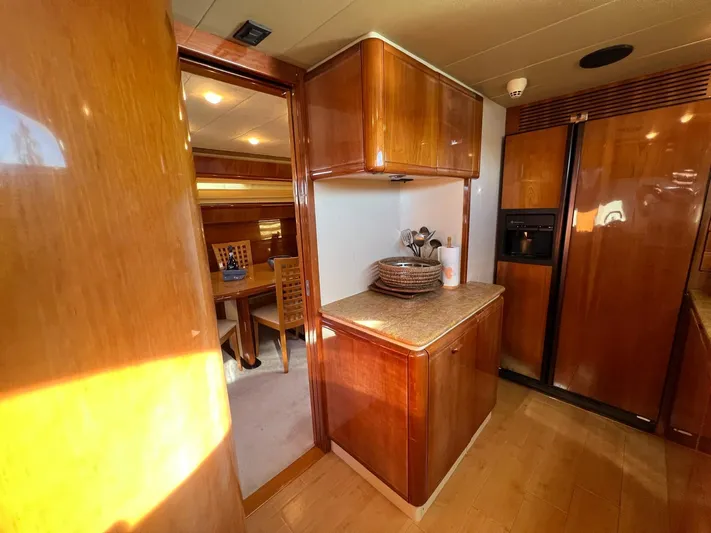  Yacht Photos Pics Luxurious interior of 2002 Ferretti Yachts 810 with wooden cabinetry and dining area.