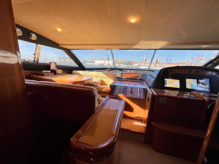  Yacht Photos Pics Luxurious interior of a 2002 Ferretti Yachts 810, featuring elegant wood finishes and panoramic windows.