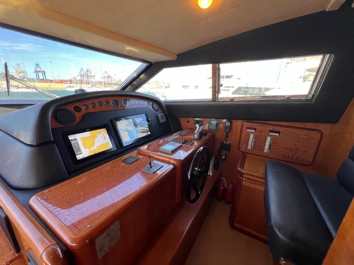  Yacht Photos Pics Helm of 2002 Ferretti Yachts 810 with navigation screens and controls.