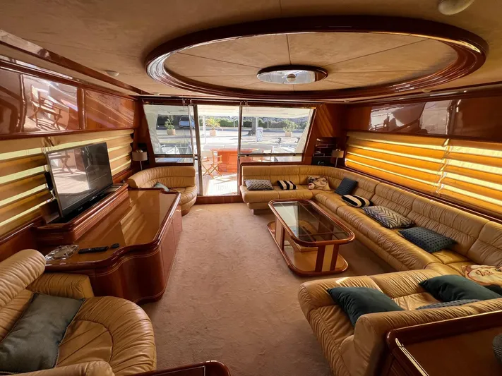  Yacht Photos Pics Luxurious interior of 2002 Ferretti Yachts 810 with plush seating and elegant wood finishes.