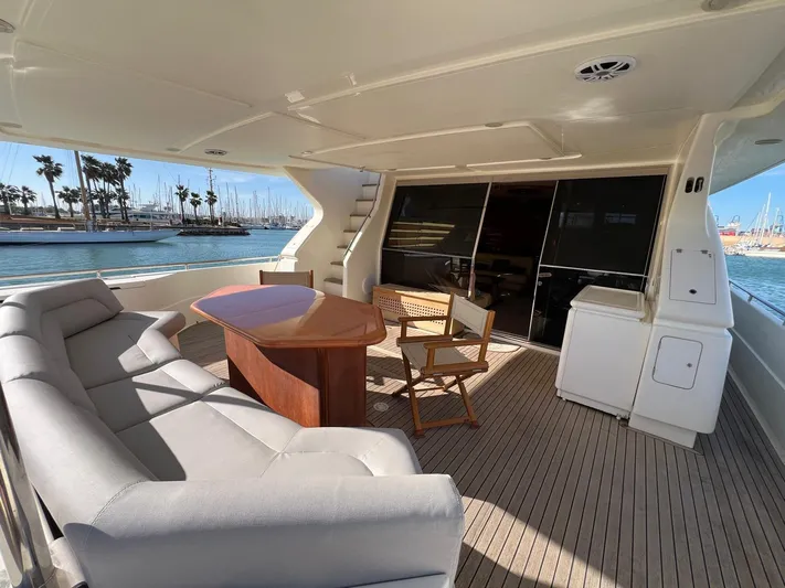  Yacht Photos Pics Luxurious 2002 Ferretti Yachts 810 deck with seating, table, and ocean view.