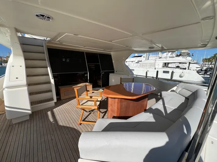  Yacht Photos Pics Luxurious 2002 Ferretti Yachts 810 deck with seating, table, and stairs.