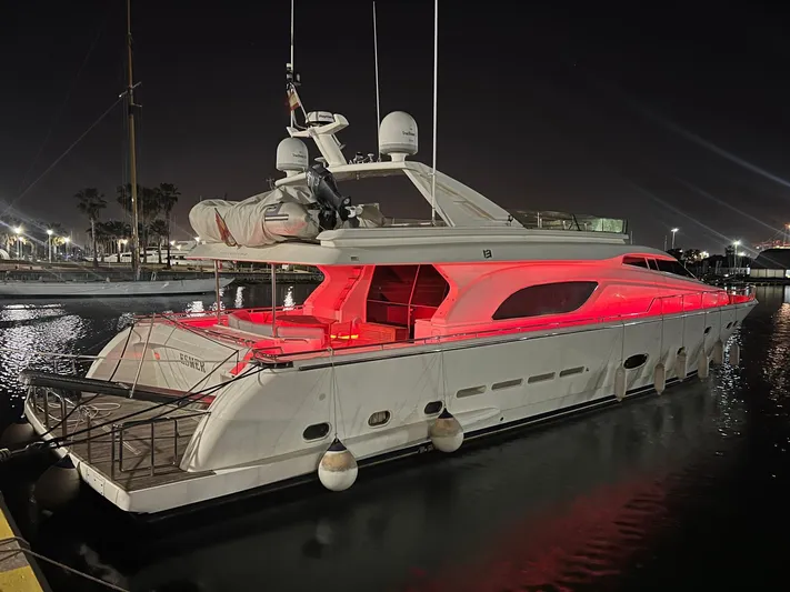  Yacht Photos Pics Luxurious 2002 Ferretti Yachts 810 illuminated at night with red lights, docked in a marina.