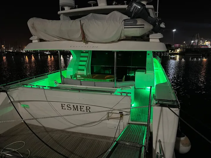  Yacht Photos Pics Ferretti Yachts 810, 2002 model, illuminated with green lights at night in a marina.