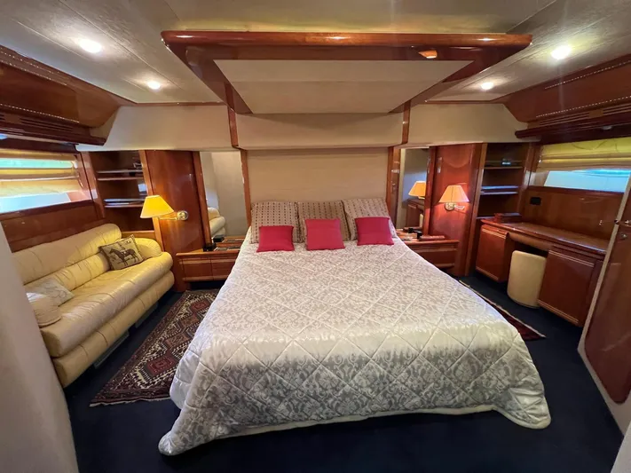  Yacht Photos Pics Luxurious bedroom interior of 2002 Ferretti Yachts 810 with elegant furnishings and ambient lighting.