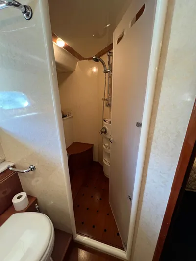  Yacht Photos Pics Bathroom interior of 2002 Ferretti Yachts 810, featuring shower and toilet.