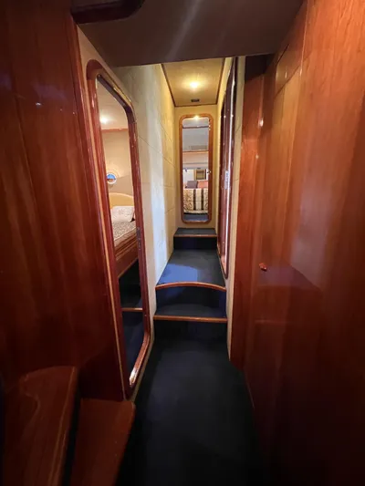  Yacht Photos Pics Luxurious hallway inside 2002 Ferretti Yachts 810, featuring elegant wood paneling.