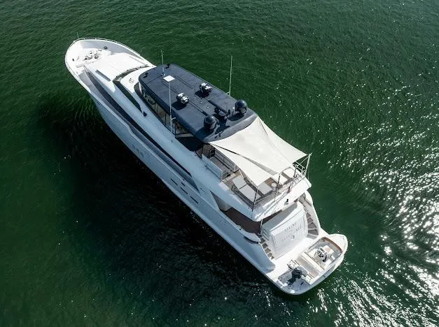 Living The Experience Yacht Photos Pics Aerial view of 2015 Hatteras 100 Raised Pilothouse yacht cruising on water.