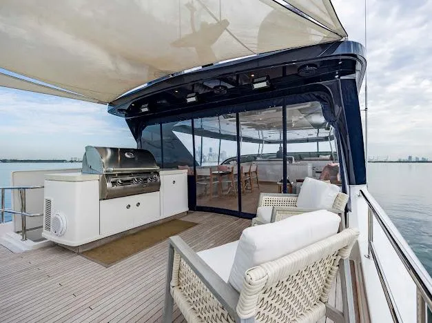 Living The Experience Yacht Photos Pics Luxury deck of 2015 Hatteras 100 Raised Pilothouse yacht with outdoor seating and grill.