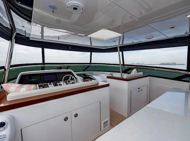 Living The Experience Yacht Photos Pics Interior of 2015 Hatteras 100 Raised Pilothouse yacht with modern helm station.