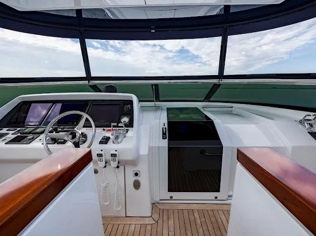 Living The Experience Yacht Photos Pics 2015 Hatteras 100 Raised Pilothouse yacht helm with modern navigation equipment and panoramic windows.
