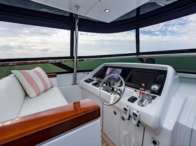 Living The Experience Yacht Photos Pics 2015 Hatteras 100 Raised Pilothouse yacht helm with modern navigation equipment and seating.