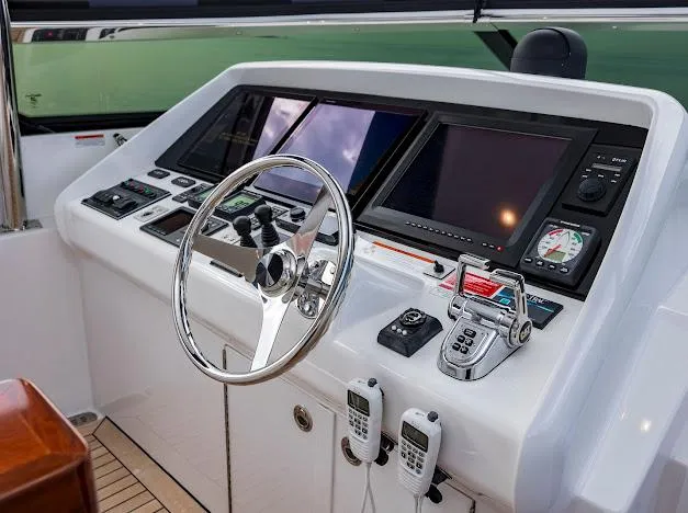Living The Experience Yacht Photos Pics Helm station of 2015 Hatteras 100 Raised Pilothouse yacht with advanced navigation controls.