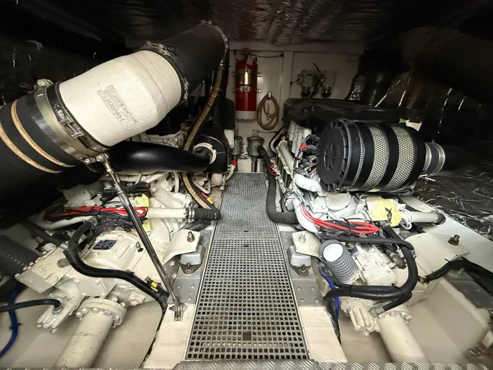  Yacht Photos Pics Engine room of a 2016 Princess 56 yacht, featuring dual engines and fire safety equipment.