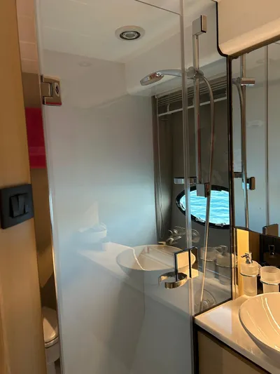  Yacht Photos Pics Luxurious bathroom in 2016 Princess 56 yacht with modern fixtures and ocean view.