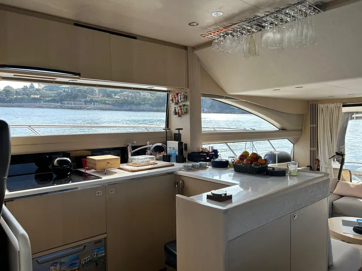  Yacht Photos Pics Luxurious interior of 2016 Princess 56 yacht with modern kitchen and scenic ocean view.