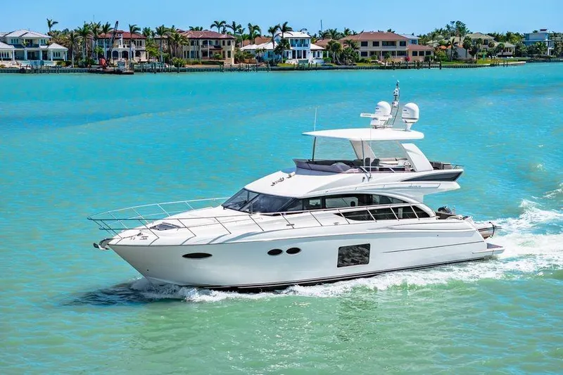  Yacht Photos Pics Luxurious 2017 Princess 56 yacht cruising on turquoise waters near waterfront homes.