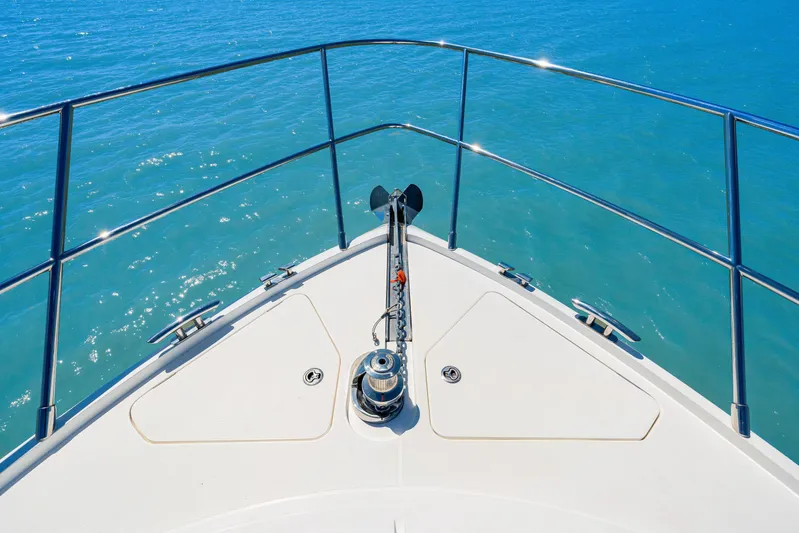  Yacht Photos Pics Bow of 2017 Princess 56 yacht with anchor, overlooking clear blue ocean.