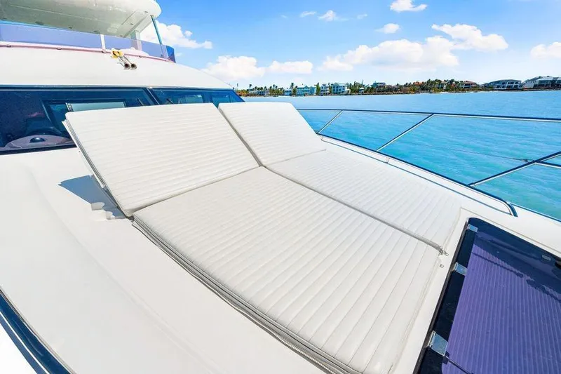  Yacht Photos Pics Luxurious 2017 Princess 56 yacht with sun loungers on deck, overlooking serene blue waters.