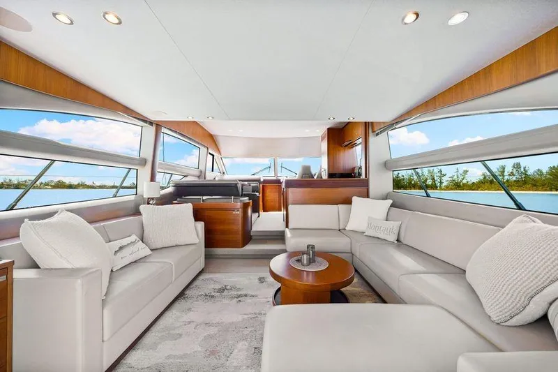  Yacht Photos Pics Luxurious interior of 2017 Princess 56 yacht with elegant seating and panoramic windows.
